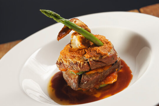 Premium Angus Beef Filet Mignon Stuffed With Carrot And Pumpkin, Garnished With Shrimp And Asparagus In Gravy Sauce.