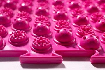 Pink acupuncture orthopedic mat. Massage mat for the prevention of flat feet in children and adults.