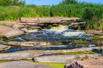 Fototapeta na wymiar View of Tokovsky waterfalls on the Kamenka river in Dnipropetrovsk region, Ukraine