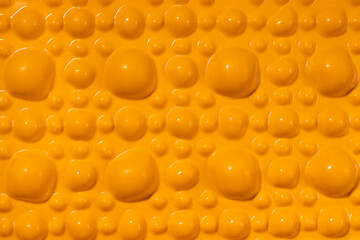 Yellow orthopedic mat in the form of small stones for foot massage. Prevention of children's flat feet