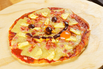 Traditional Italian pizza with tomato sauce, ham, pineapple and pepperoni.