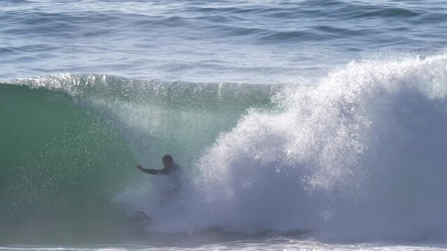 surfer falling from surf board in wave water slow motion 4k