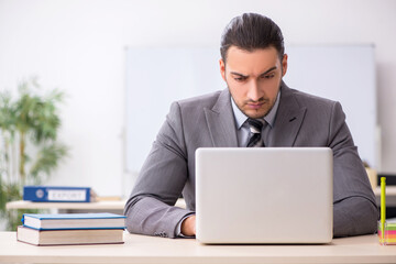 Young male employee working in the office