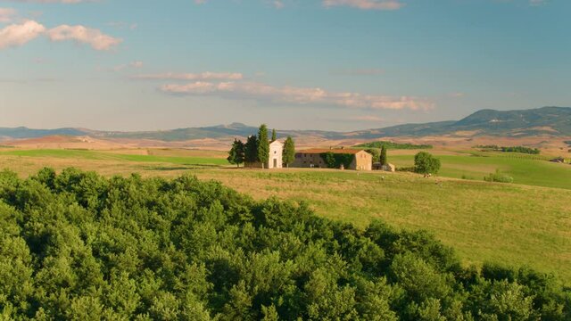 Aerial footage of Chapel of the Madonna di Vitaleta,  illuminated by setting sun. Tuscany, San Quirico d’Orcia, Italy. Apple ProRes codec.  