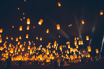 Loy krathong festival, thai new year party with floating lanterns release in the night sky