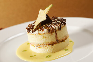 Vanilla dessert with custard, chocolate and star-shaped biscuit.