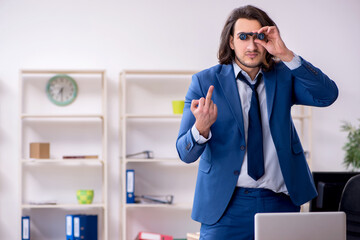 Young male employee unhappy with excessive work