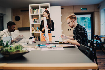 Young team of designers preparing for presentation
