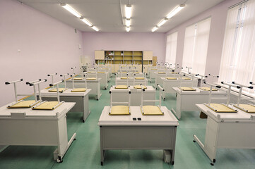 classroom without students - educational class with study desks and overturned chairs