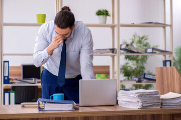 Young male employee unhappy with excessive work
