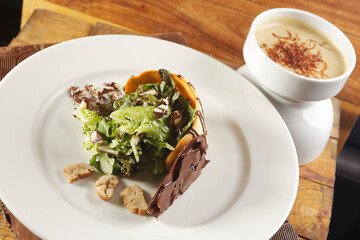 Lettuce salad with walnut, biscuit and chocolate.