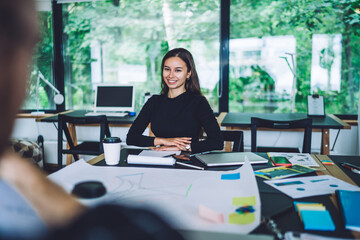 Happy female freelancer working with colleague