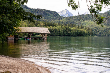 Fototapeta na wymiar Old boathouse at quiet mountain lake