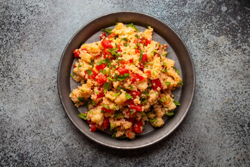 Middle eastern and Mediterranean traditional vegetable salad tabbouleh, from above. Arab snack or appetizer, light and healthy food, top view .
