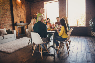 Portrait of nice attractive adorable family parents grandparents grandchildren enjoying cutting...