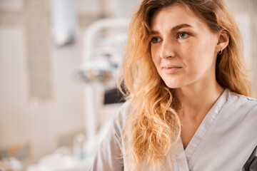 Female dentist looking focused in her office