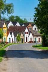 many colorful old traditional wine cellers in Villanykovesd in a hungarian wine region called Villany