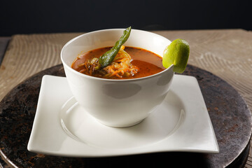 Shrimp broth and fish fillet with vegetables.