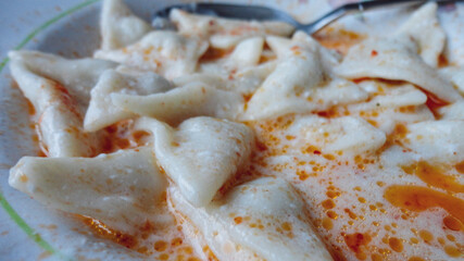 Traditional Turkish cuisine Ravioli, Manti Manlama serving with yogurt and fried butter sauce. 