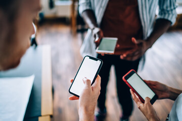 Faceless man watching mobile creating project with partners in office