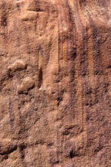 Background of red stone surface with mineral inclusions. Crater Ramon. Israel