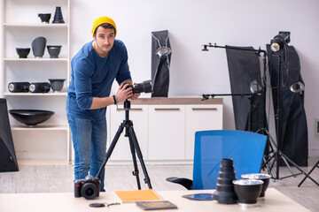 Young male photographer working in the studio
