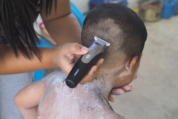 Boy cutting hair by thai stlye
