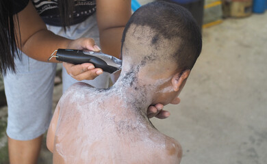 Boy cutting hair by thai stlye