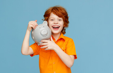 Optimistic boy with piggy bank