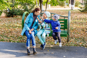 Mother and her children eating ice cream and having fun