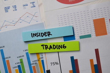 Insider Trading write on sticky notes with graphic on the paper isolated on office desk.