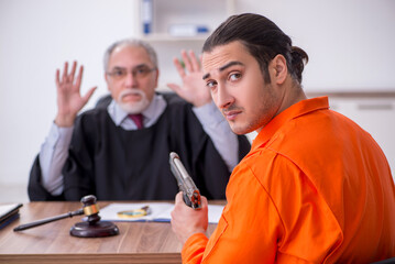Old male judge meeting with young captive in courthouse