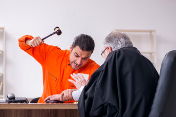 Old male judge meeting with young captive in courthouse