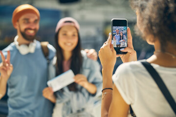 Screen of smartphone in hands of African female