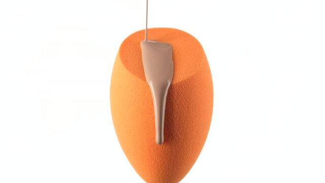 liquid foundation pour on yellow make up blender sponge for apply on face. white background
