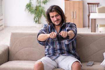 Fototapeta premium Young male student in poverty concept
