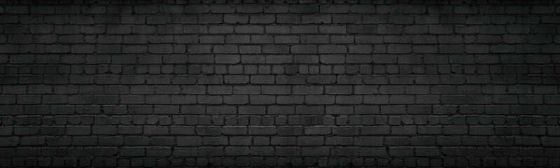 Black brick wall wide texture. Gloomy dark brickwork widescreen background