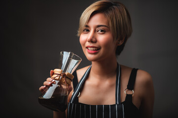 Professional female barista smiling, portrait of young female coffee maker in the cafe