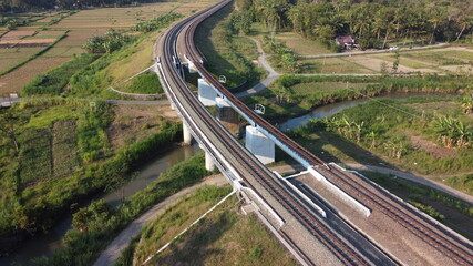 aerial view of train tracks across the river. beautiful scenery