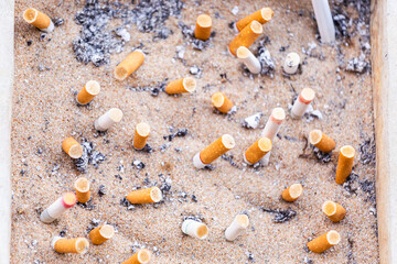 Many Cigarette butts discarded in ashtray