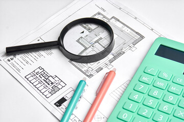 Architectural project, blueprints, magnifying glass, calculator, model house on construction plan for house building.
