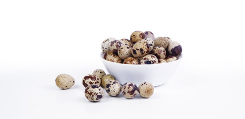 Quail eggs in a plate on a white background