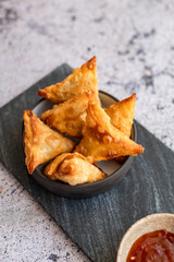 Fried Samosa (samoosa) triangle pastries on a light surface
