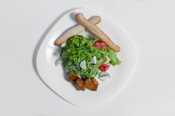 healthy salad with tomato, feta and grilled meat on white background