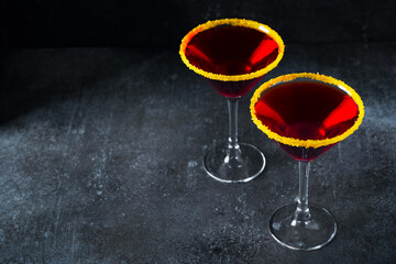 Halloween concept with red coctail Black widow in glass on dark background