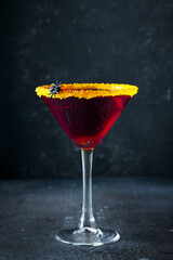 Halloween coctail black widow with red drinks in glass on dark background