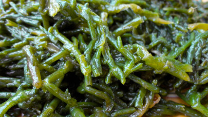Close-up of fresh boiled sea beans. Turkish and Greek healthy Salicornia olive oil herb salad.