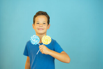 Smiling boy with lollipops in hand