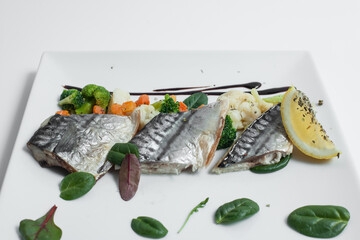 steam cooked mackerel fish with vegetables isolated