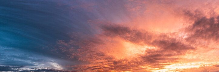 Naklejka na ściany i meble Colorful and dramatic sky panorama of sunset background